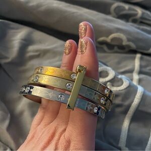 Set of three attached silver tone and gold tone rhinestone bangle bracelets